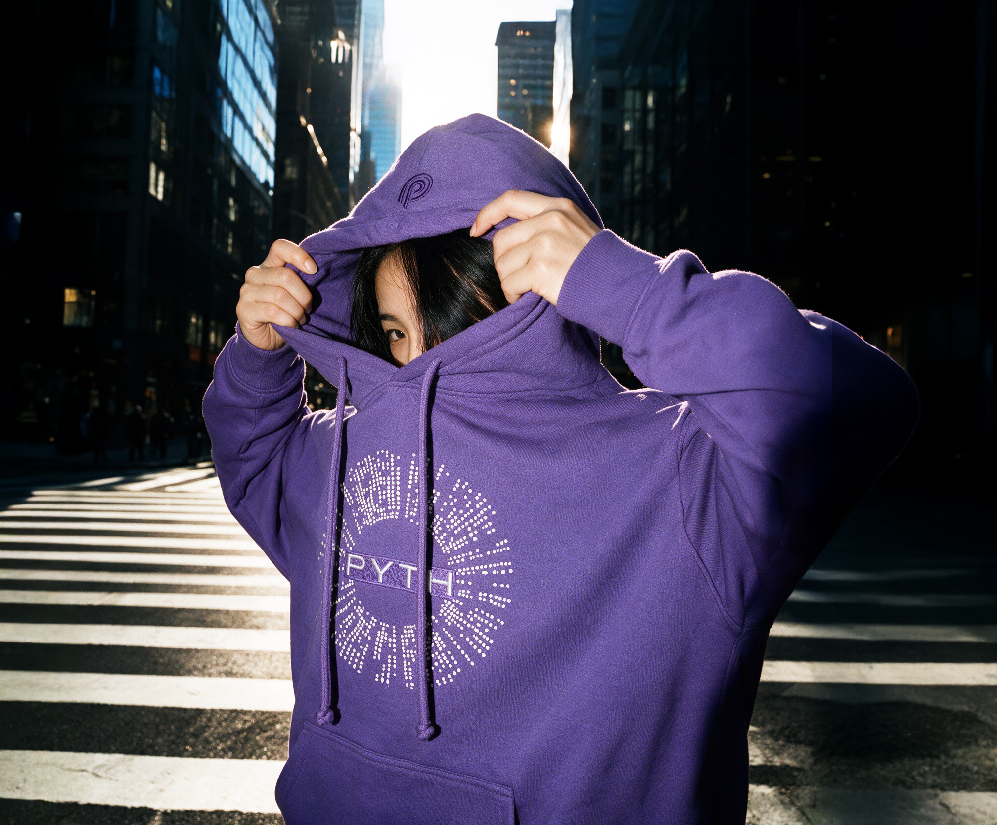 PYTH Network purple hoodie in city light